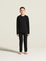 Zwart | sfeer | Op model met bijpassend shirt, zwart – Craft thermobroek kinderen - Thermal Baselayer JR